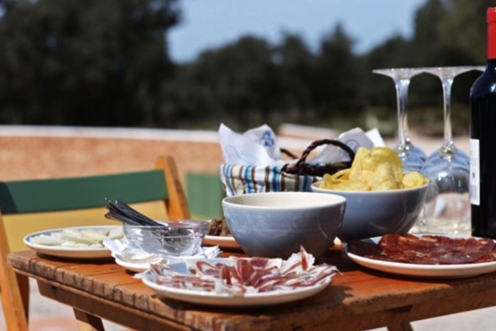 spanish jamon and wine on a table